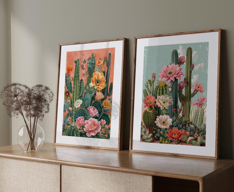 May include: Two framed botanical prints featuring colorful cactus flowers in a vintage style. The prints are in wooden frames and have a light background.