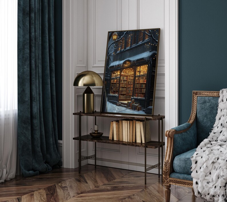 May include: A framed print of a bookstore with a snowy street scene. The bookstore is lit up with warm yellow lights and has a sign that reads "The Book Nook".