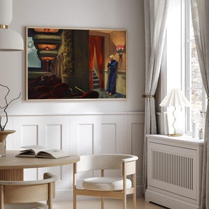May include: A framed painting of a woman in a blue dress standing in a theater lobby. The painting is set against a white wall with white wainscoting.