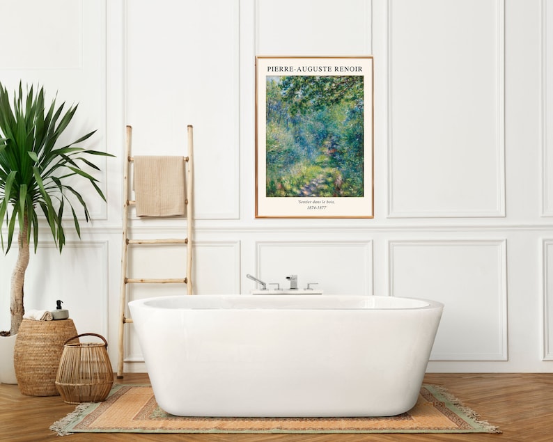 K&ouml;nnte beinhalten: Eine wei&szlig;e Badewanne mit verchromten Armaturen steht in einem Badezimmer mit wei&szlig;en W&auml;nden und T&auml;felung. Links von der Wanne steht eine Holzleiter mit einem dar&uuml;bergelegten Handtuch. An der Wand &uuml;ber der Wanne h&auml;ngt ein gerahmter Druck eines Gem&auml;ldes von Pierre-Auguste Renoir mit dem Titel "Boulevard des Italiens". Zwei Weidenk&ouml;rbe stehen auf dem Boden links von der Wanne.