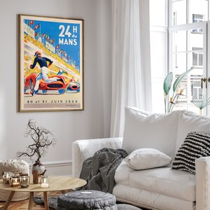 May include: A vintage poster advertising the 24 Hours of Le Mans race, featuring a red race car speeding down a track with a driver in a white racing suit. The poster is set against a blue sky with white clouds and has the text "24 H du MANS" in bold, black letters. The date "20 et 21 JUIN 1959" is printed at the bottom of the poster.