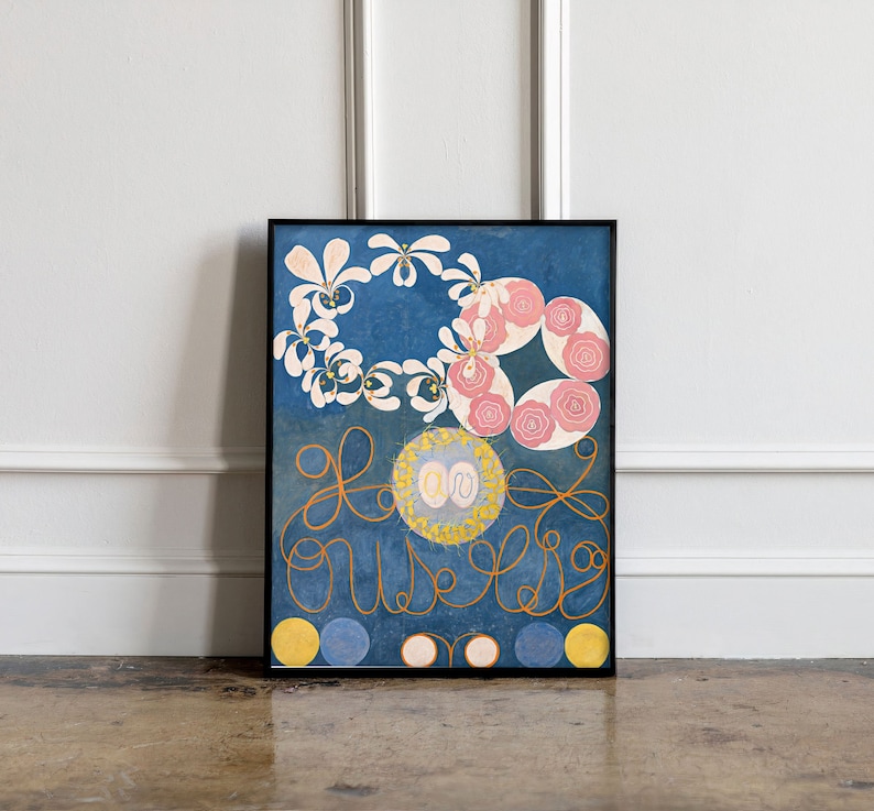 May include: A framed print of a painting with a blue background, white and pink flowers, and a gold swirl design. The text "Love" is written in a cursive font.