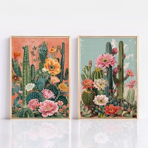 May include: Two framed prints of vintage botanical illustrations featuring cacti and flowers. The print on the left has a pink background and the print on the right has a blue background.