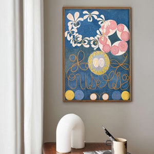 May include: A framed print of a painting with a blue background, white and pink flowers, and yellow circles. The painting is in a wooden frame.