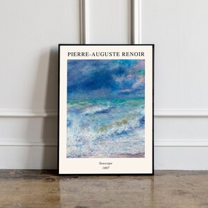 May include: A framed print of a seascape painting by Pierre-Auguste Renoir. The painting depicts a stormy sea with white-capped waves and a blue sky with clouds. The text "Seascape 1897" is printed below the painting.