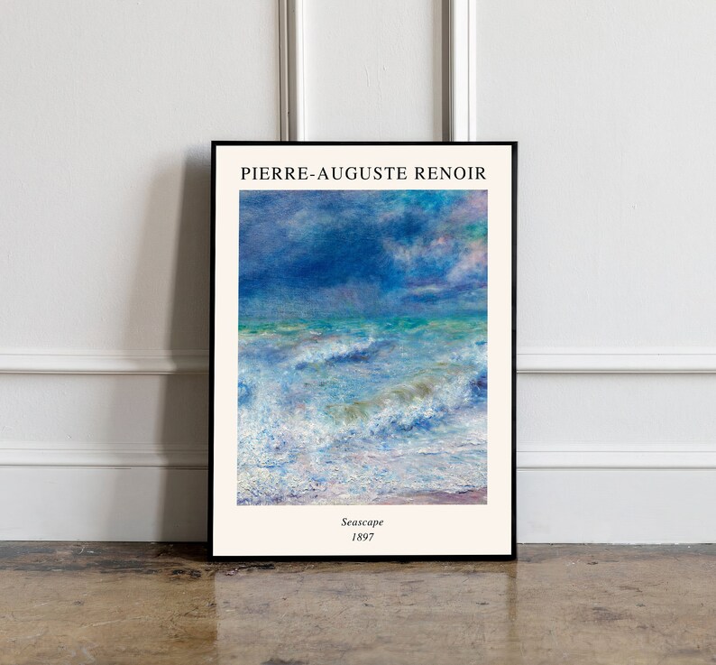 May include: A framed print of a seascape painting by Pierre-Auguste Renoir. The painting depicts a stormy sea with white-capped waves and a blue sky with clouds. The text "Seascape 1897" is printed below the painting.