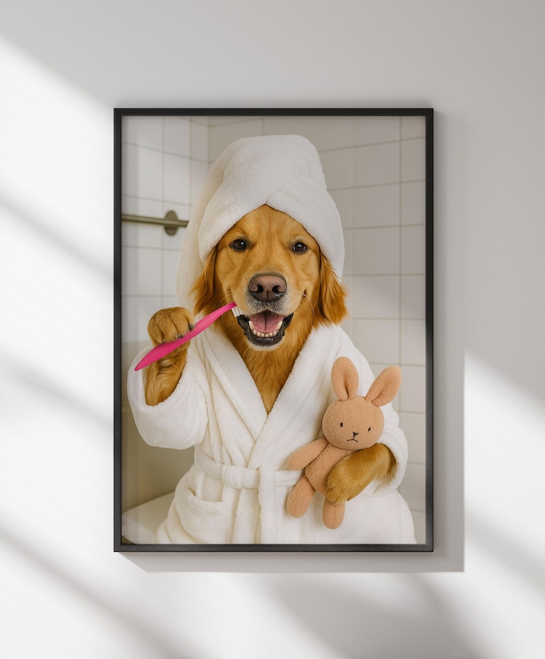 May include: A framed print featuring a Golden Retriever wearing a white bathrobe and towel, brushing its teeth with a pink toothbrush. The dog holds a small brown stuffed bunny. The background shows a tiled wall.