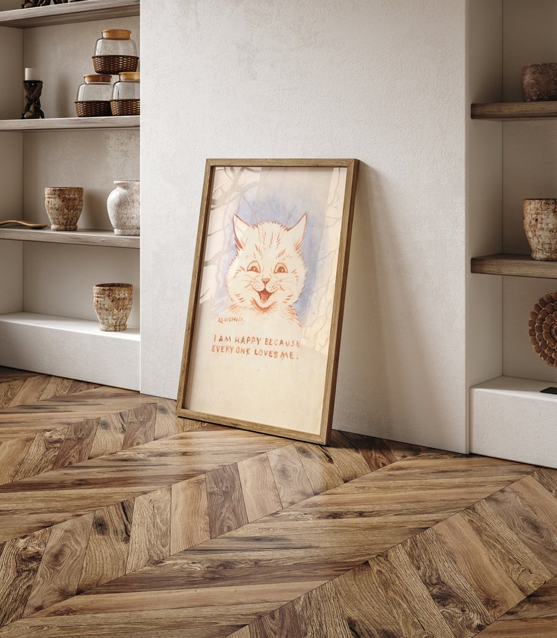 May include: A framed illustration of a white cat with a happy expression. The cat is surrounded by a light blue background with a light brown frame. The text below the cat reads "I am happy because everyone loves me."