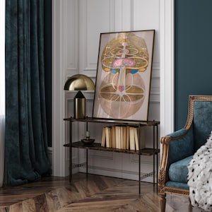 May include: A framed print of a colorful abstract design with geometric shapes and circles. The print is hanging on a wall above a shelf with books and a lamp.