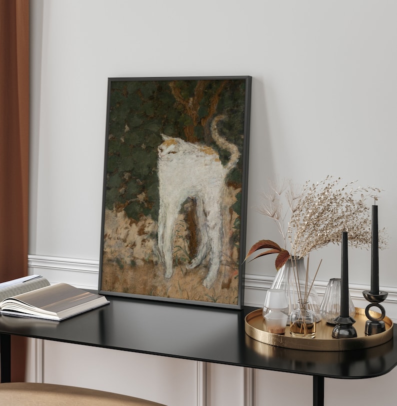 May include: A framed painting of a white cat with a long tail standing in a green and brown landscape.