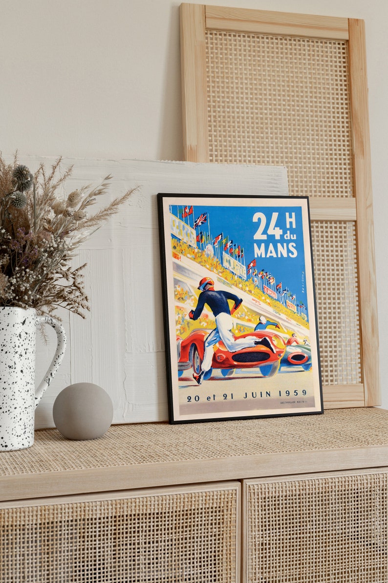 May include: A vintage poster for the 24 Hours of Le Mans race, featuring a blue sky, a red race car, and a driver running towards the finish line. The poster text reads "24H du MANS 20 et 21 JUIN 1959".