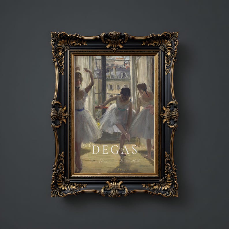 May include: A framed print of a painting by Edgar Degas depicting three ballerinas in a dance studio. The painting is in a black frame with gold accents. The title of the painting is "Degas -  Three Dancers in a Dance Hall"