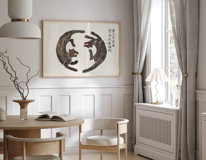 May include: A black and white print of two tigers facing each other in a circle. The print is framed and hanging on a white wall. The text in the image reads "學而不思則罔 思而不學則殆".