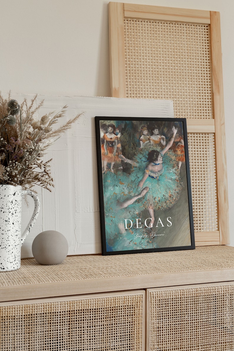 May include: A black framed poster with a painting of dancers in a green and blue color scheme. The poster has the text "Degas" in white lettering at the bottom.