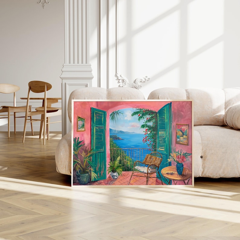 May include: A painting of a pink room with a window open to a view of the ocean. The window is framed by green shutters and there is a chair and a table on the balcony.
