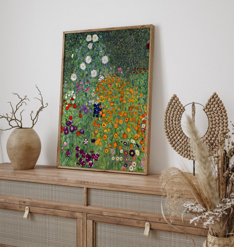 May include: A framed painting of a garden with a variety of flowers in shades of orange, white, purple, and green. The flowers are arranged in a loose, natural pattern, and the background is a soft green.