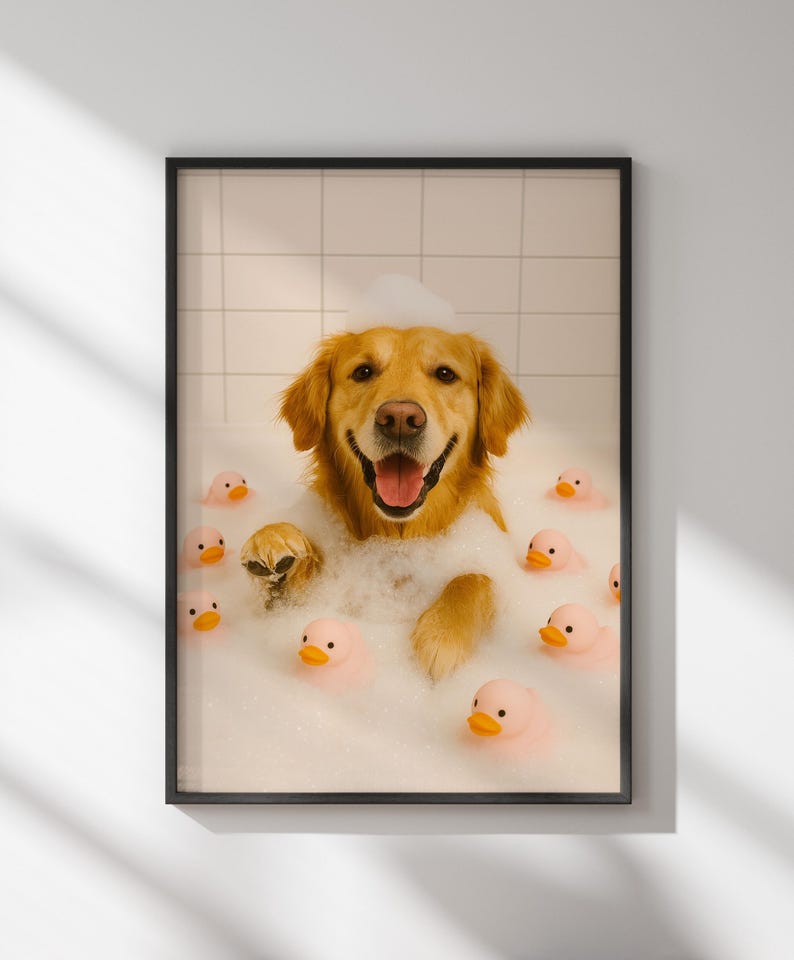 May include: Framed print of a Golden Retriever dog in a bubble bath, surrounded by pink rubber duckies. The dog is smiling with its tongue out, and the bubbles cover its head and body.