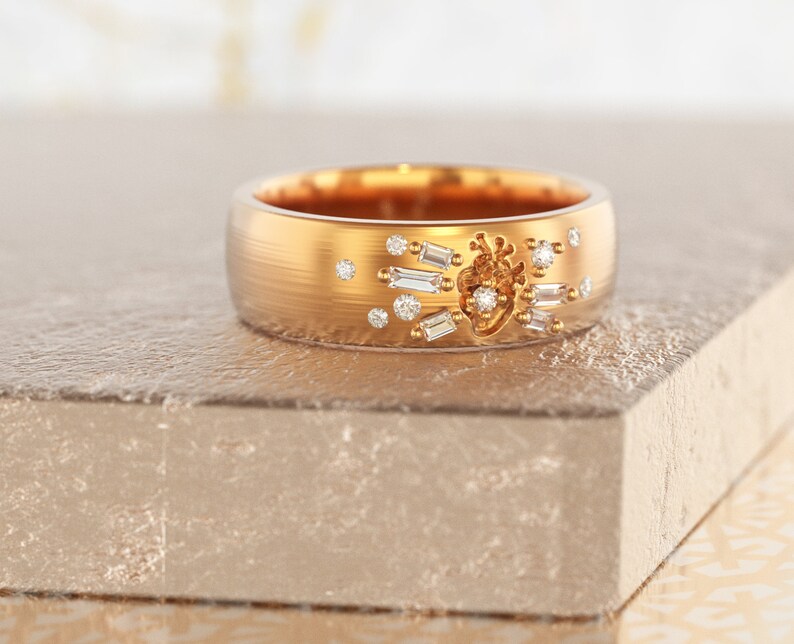 May include: A gold band ring with a heart design and small diamonds set in the band.