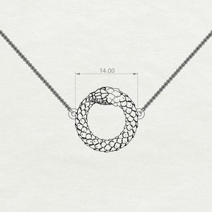 May include: A silver snake chain necklace with a snake pendant that is curled into a circle. The pendant is 14.00 inches in diameter.
