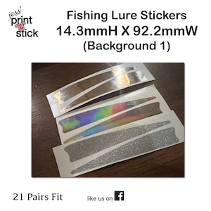 May include: A set of 21 pairs of fishing lure stickers in various finishes, including silver, iridescent, and glitter. The stickers are 14.3mm high and 92.2mm wide. The text "Fishing Lure Stickers 14.3mmH X 92.2mmW (Background 1)" is printed above the stickers.