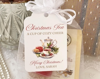 May include: A white rectangular gift tag with rounded corners, tied with a white organza ribbon. The tag features the text Christmas Tea, A CUP OF COZY CHEER, Merry Christmas!, and LOVE, SARAH, alongside a watercolor illustration of a teapot and teacup.