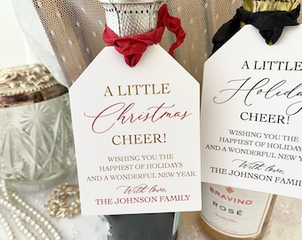 May include: Two white gift tags with gold and red lettering. The tags read "A Little Christmas Cheer! Wishing you the happiest of holidays and a wonderful new year. With love, The Johnson Family." and "A Little Holiday Cheer! Wishing you the happiest of holidays and a wonderful new year. With love, The Johnson Family."