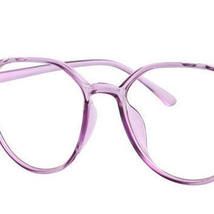 May include: A pair of round, light purple spectacles with clear lenses.