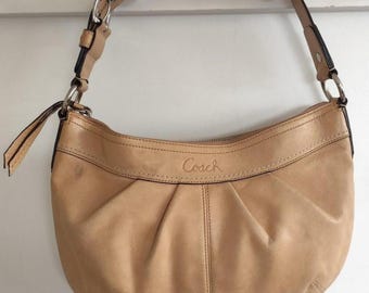 Tan leather Coach shoulder bag with adjustable straps