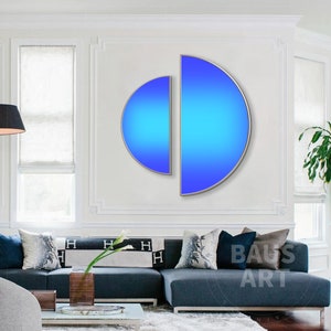 May include: Two semi-circular wall art pieces with a vibrant blue gradient finish, framed in thin metallic borders. The left piece is smaller and positioned slightly lower than the larger right piece, creating a modern geometric composition.