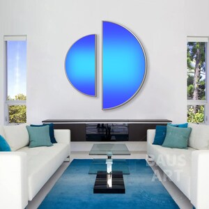 May include: A wall art piece consisting of two semi-circular panels with a vibrant blue gradient finish, framed in a thin metallic border. The left panel is smaller and positioned slightly lower than the larger, taller right-hand panel.