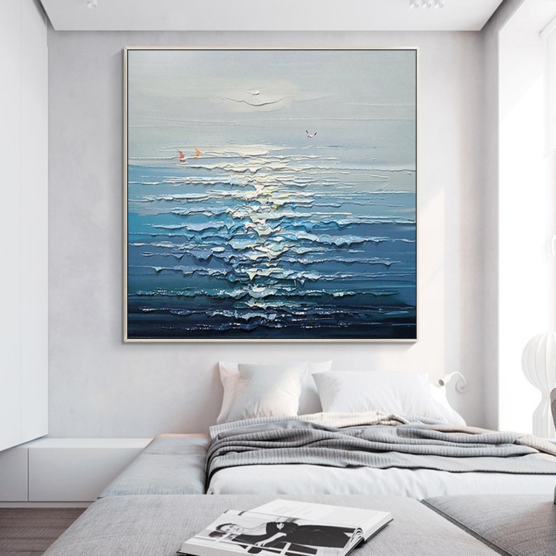 May include: A painting of a seascape with blue and white waves, a light blue sky, and two small red sailboats in the distance.
