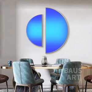 May include: Two semi-circular wall art pieces with a vibrant blue gradient finish, framed in thin metallic borders. The left piece is smaller and positioned slightly lower than the larger right piece, creating a modern geometric display.