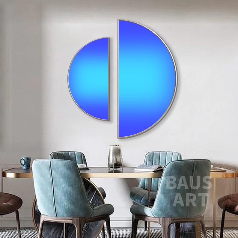 May include: Two semi-circular wall art pieces with a vibrant blue gradient finish, framed in thin metallic borders. The left piece is smaller and positioned slightly lower than the larger right piece, creating a modern geometric display.
