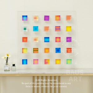 May include: A colorful abstract painting with a grid of 24 squares, each filled with a gradient of color. The painting is framed in a clear acrylic frame and has a circular stamp in the lower right corner that reads "Original Art Painting 2021".