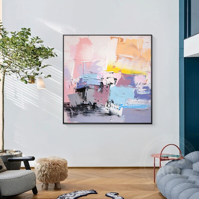 May include: Abstract painting with a mix of pink, purple, blue, yellow, and black paint. The painting has a textured look and is framed in a black frame.