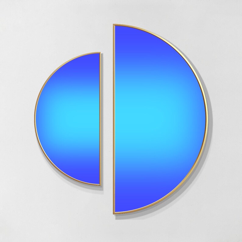 May include: Two semi-circular wall art pieces with a vibrant blue gradient finish, ranging from deep royal blue to bright cyan. Each piece is framed in a thin, metallic gold border, creating a clean, geometric display of two separate halves.