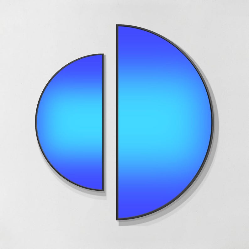 May include: A wall art piece consisting of two separate semi-circular panels framed in thin black metal. Each panel features a vibrant blue gradient that transitions from a lighter cyan in the centre to a deeper royal blue at the curved edges.
