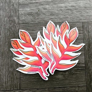 May include: A set of five red and orange tropical flower stickers with the text "@tahnzpaifio" on each sticker.