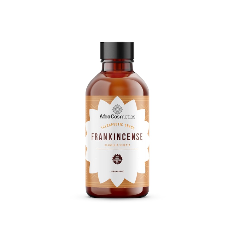May include: A brown glass bottle with a black cap, labeled "AfroCosmetics Therapeutic Grade Frankincense Boswellia Serrata Pure Essential Oil USDA Organic".