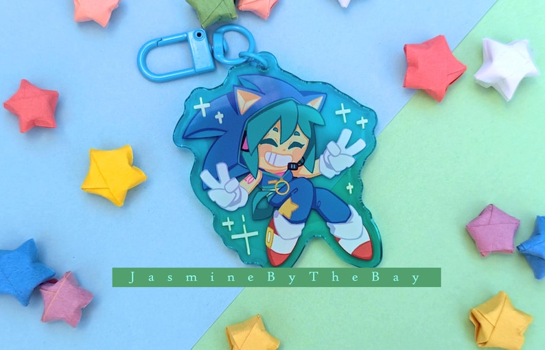 May include: A blue and green character with a blue and white striped shirt and a blue headband. The character is holding a peace sign with both hands. The character is on a clear blue background with white stars.