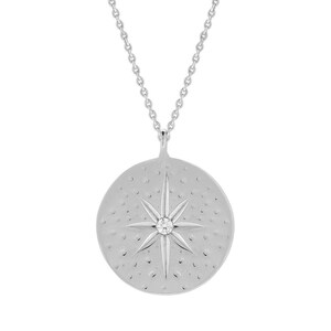 May include: Silver necklace with a round pendant featuring a starburst design with a small diamond in the center.
