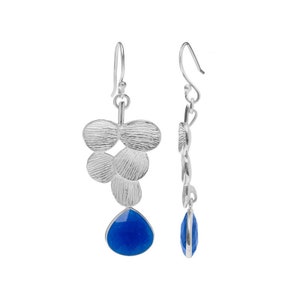 May include: Silver dangle earrings with a cluster of textured silver discs and a teardrop-shaped blue gemstone.