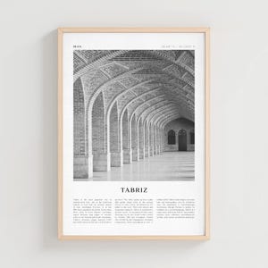 May include: A framed black and white print featuring an arched hallway with brick columns and a patterned ceiling. The print includes the word "TABRIZ" and text about the city. The frame is a light wood color.