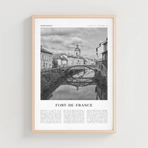 May include: Black and white framed print of Fort-de-France, Martinique. The image shows a bridge over a river, with buildings and a church in the background. The print includes the text "Fort-de-France" and other descriptive text.