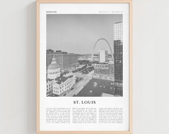 May include: A framed black and white print featuring a cityscape of St. Louis, Missouri. The image includes the Gateway Arch, buildings, and text that reads "MISSOURI" and "ST. LOUIS". The frame is a light wood color.
