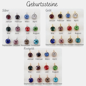 May include: A collection of birthstone pendants in silver, gold, and rose gold. Each pendant features a round, colored gemstone, with months of the year labeled below. The German text "Geburtssteine" is at the top.