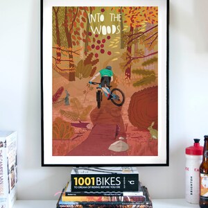 Peut inclure: Une illustration color&eacute;e d'un cycliste de montagne traversant une for&ecirc;t. Le texte "INTO THE WOODS" est en haut de l'image.