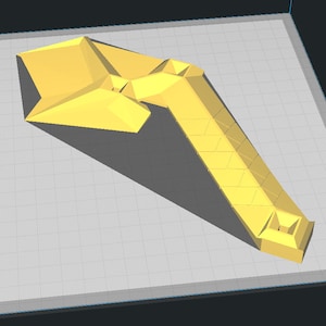 May include: A yellow plastic 3D printed model of a tool with a flat, wide head and a long, narrow handle.