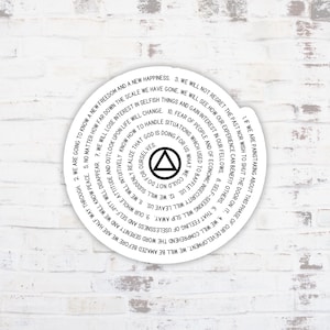 May include: A white circle with a black triangle inside. The circle contains text in a spiral pattern. The text reads: "1. If we are painstaking about this phase of our development. We will be amazed before we are half way through. 2. We are going to know a new freedom and a new happiness. 3. We will not regret the past nor wish to shut the door on it. 4. We will comprehend the word serenity and we will know peace. 5. No matter how far down the scale we have gone. We will lose interest in selfish things and gain interest in our fellows. 8. That feeling of uselessness and self-pity will disappear. 7. We will intuitively know how to handle situations which used to baffle us. 12. We will suddenly realize that God is doing for us what we could not do for ourselves. 6. Our whole attitude and outlook upon life will change. 10. Fear of people and of economics will slip away. 9. The insecurity will leave us. 11. We will lose interest in selfish things and gain interest in our fellows."