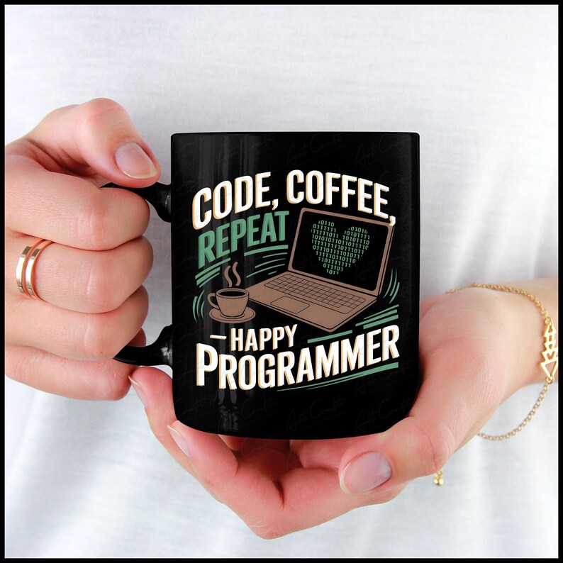 May include: Black coffee mug with a white design that says "Code, Coffee, Repeat - Happy Programmer". The design also includes a laptop with a green heart made of binary code.